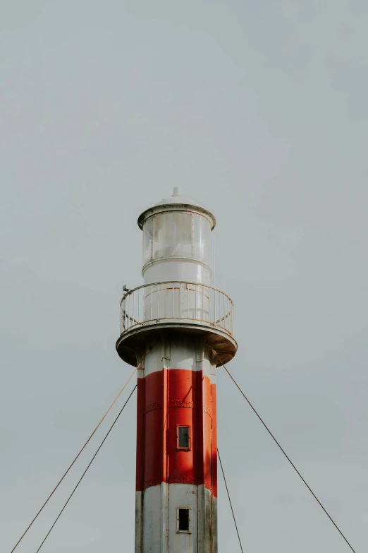 a light house with two red and white lights