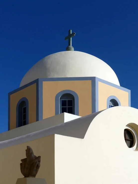 a church with a white dome and cross on top of it