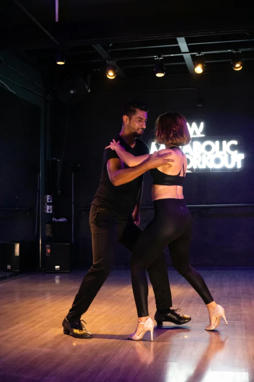 a couple dancing with the words'i want love dance'projected in the background