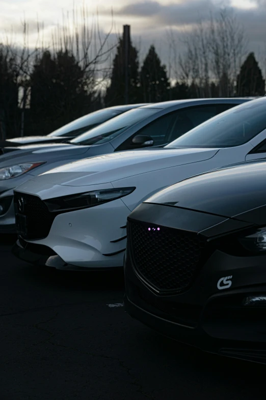 a row of parked cars sitting on the side of a street