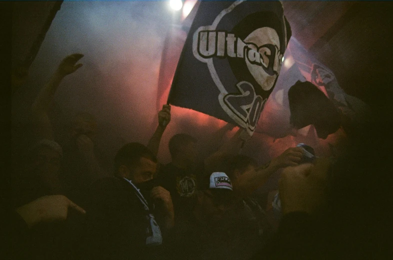 a couple of people with a flag in a crowd