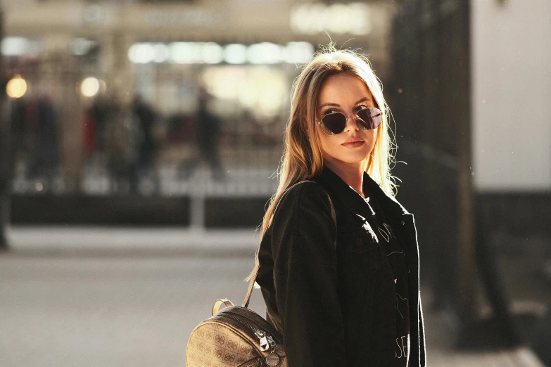 blonde woman in sunglasses walking on sidewalk