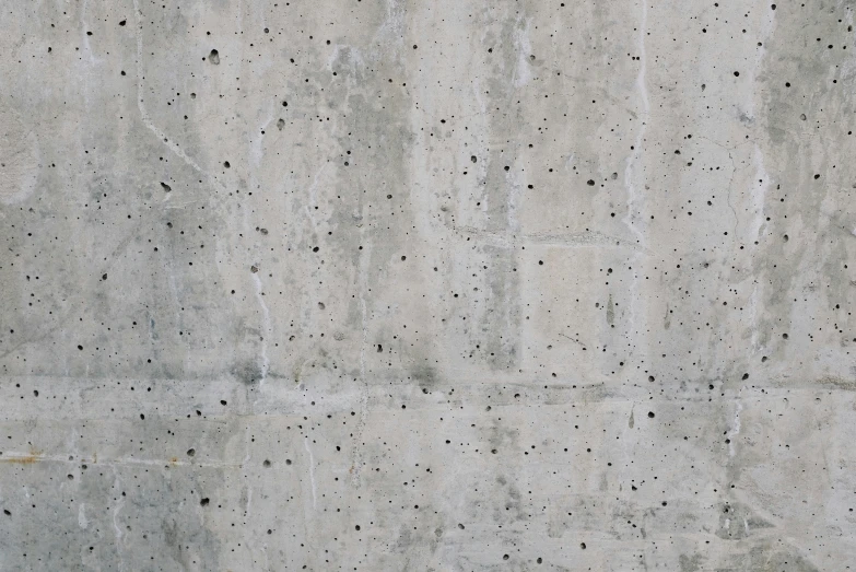 a white building with cement walls and small dots on it