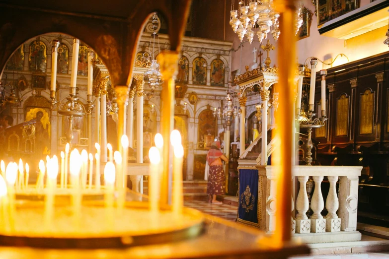 a large altar with many lit candles behind it