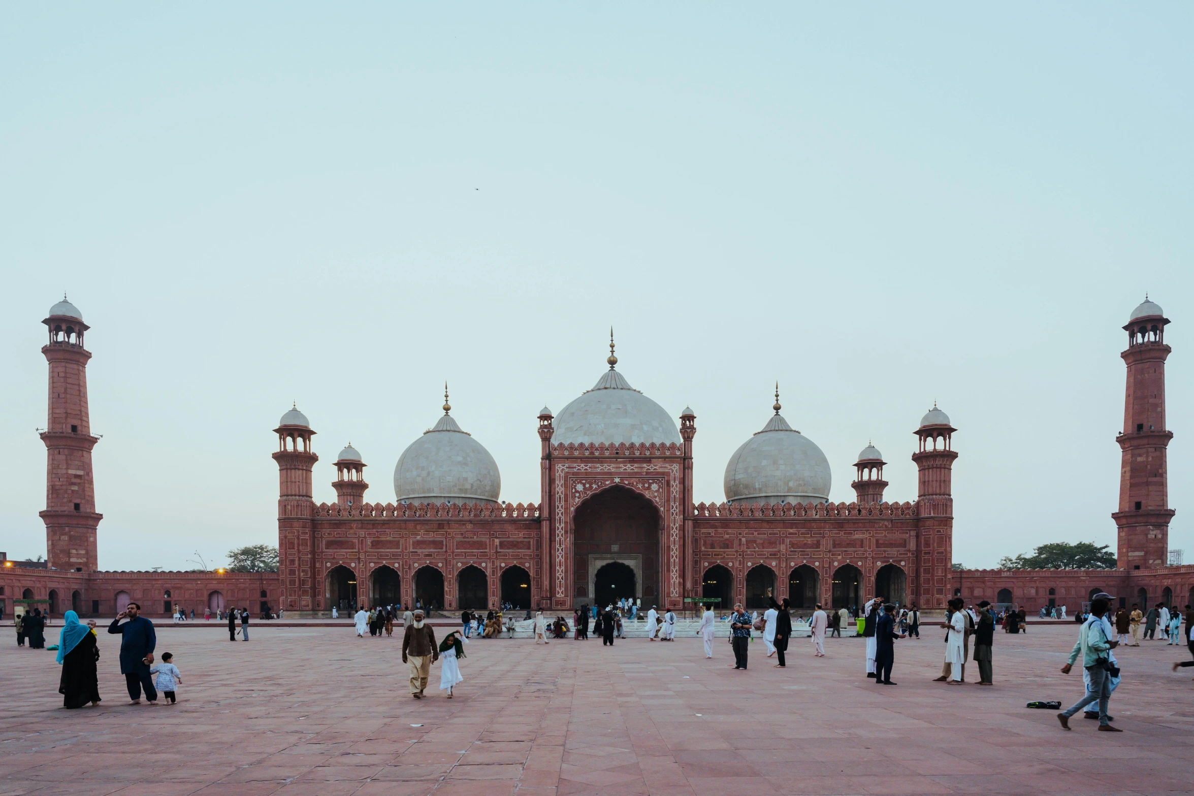 some people and some are standing on a brick surface