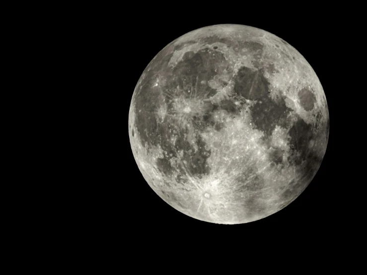 an airplane flies in front of the full moon