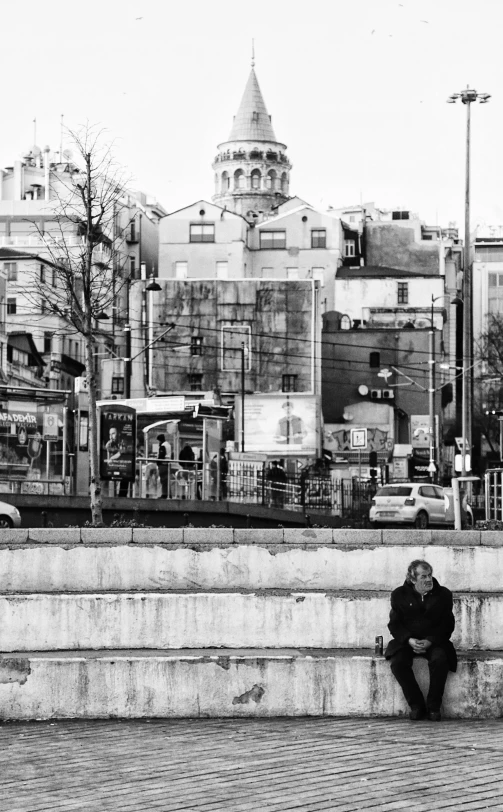 a man that is sitting down on some steps