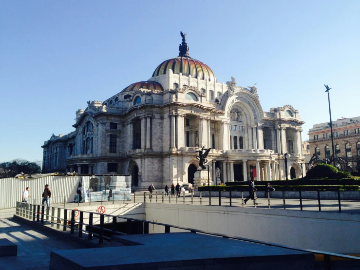 a large building with a dome next to a fence