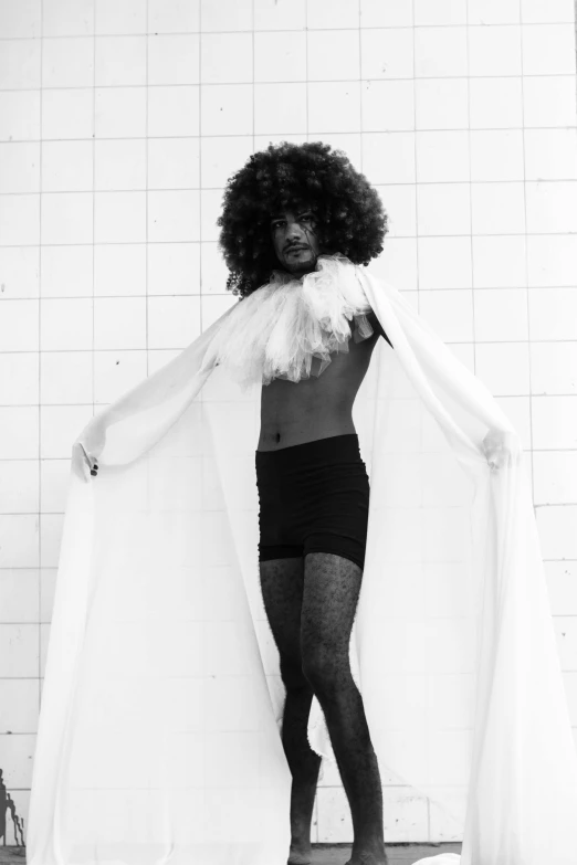 a woman posing with an afro wig and black panties