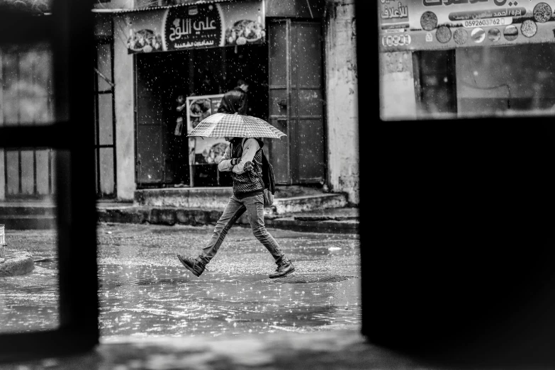 a person is crossing the street with an umbrella