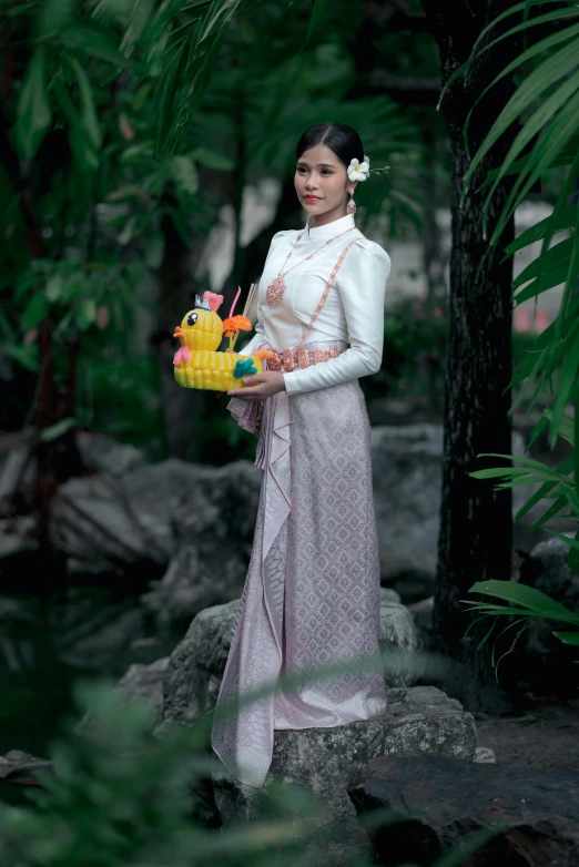 a woman wearing an asian dress standing outside