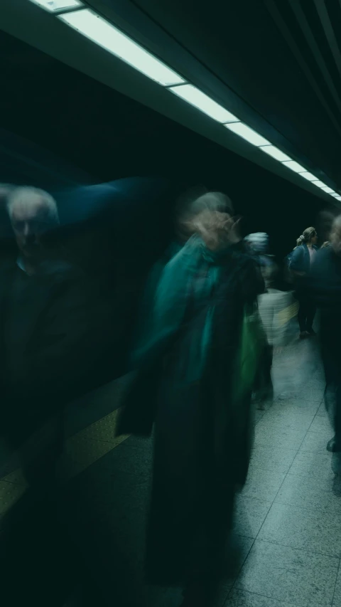 blurred image of people walking in subway platform