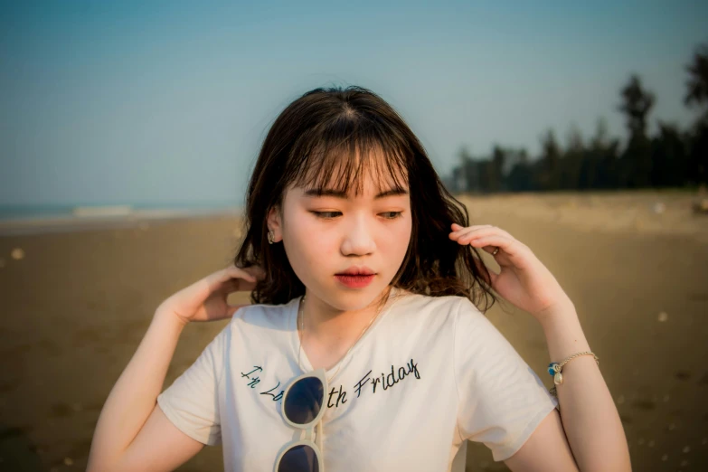 a young woman standing in front of the beach