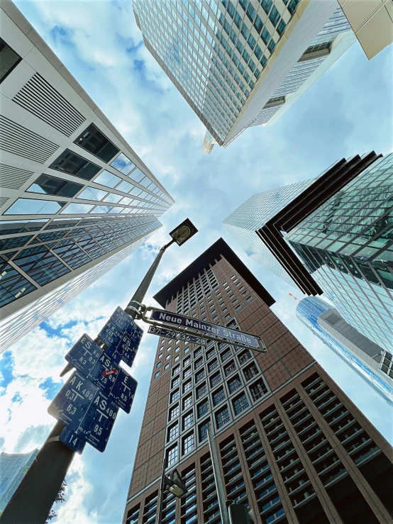 a view from below of tall buildings in an intersection