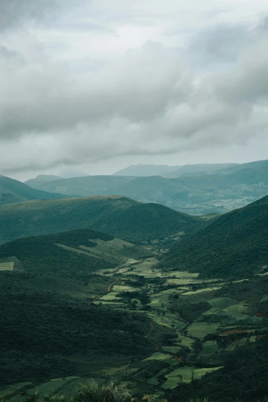 a scenic view of rolling countryside and clouds