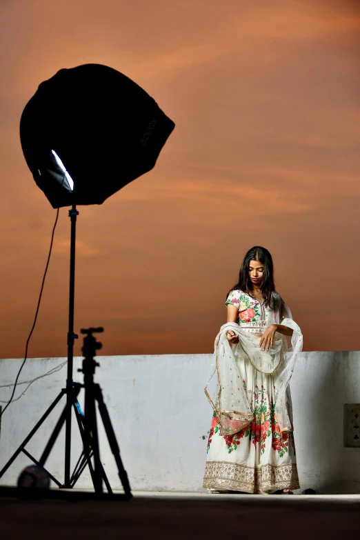 a po shoot of a woman in a long dress