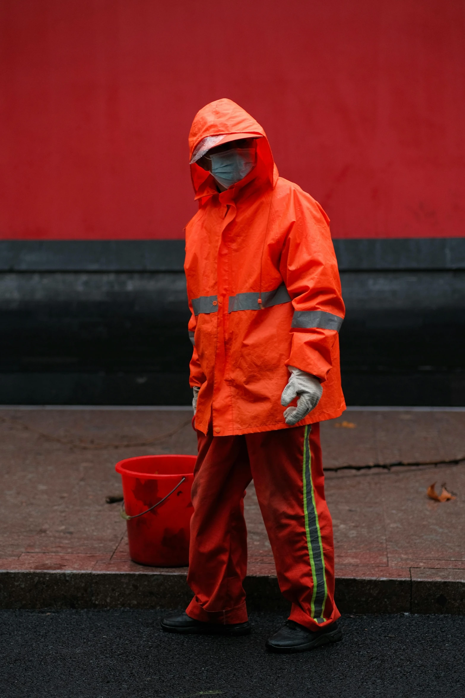 a person wearing an orange reflective coverall