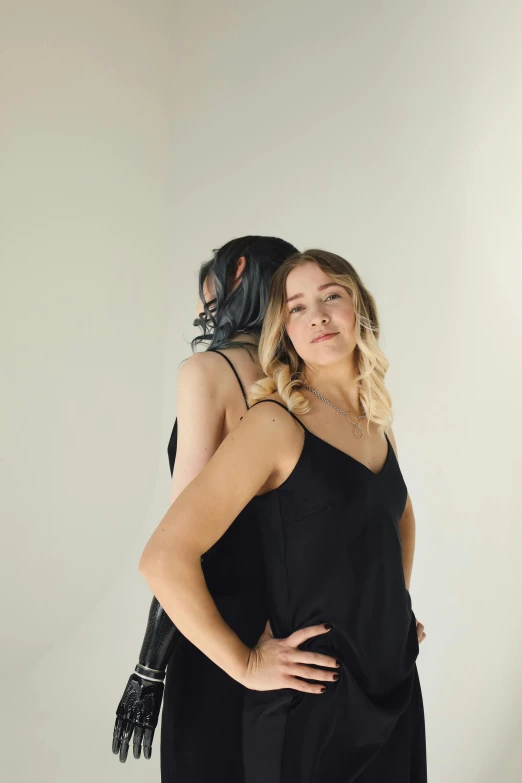 two people are dressed in black to appear to be hugging each other