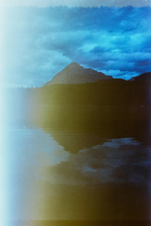 a landscape view of some water, with mountains in the distance