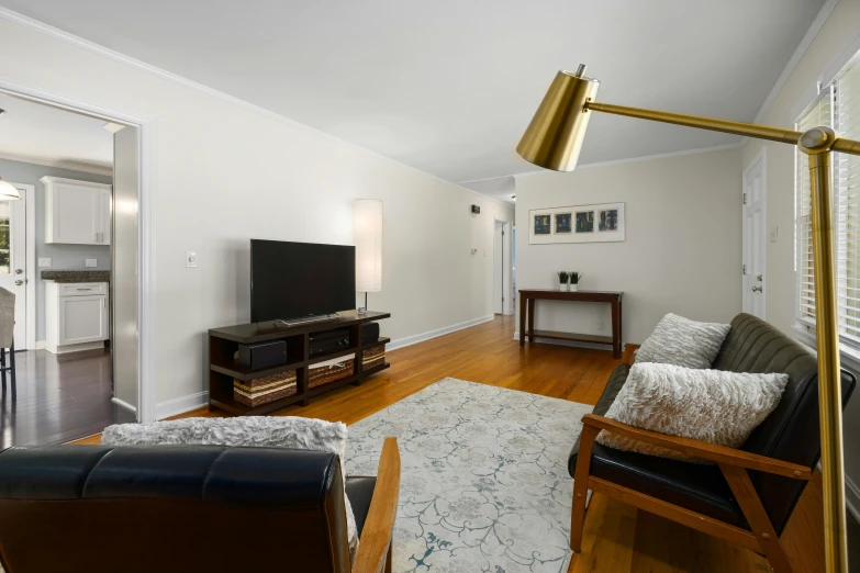 the large open concept living room features wood floors and modern decor