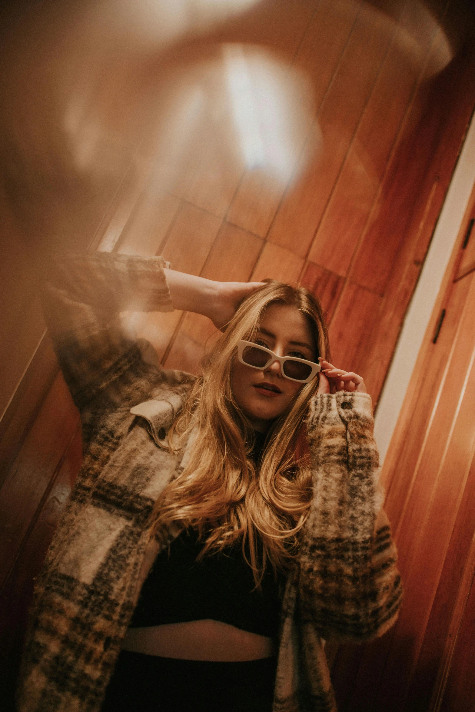 a woman is taking a picture in front of the mirror