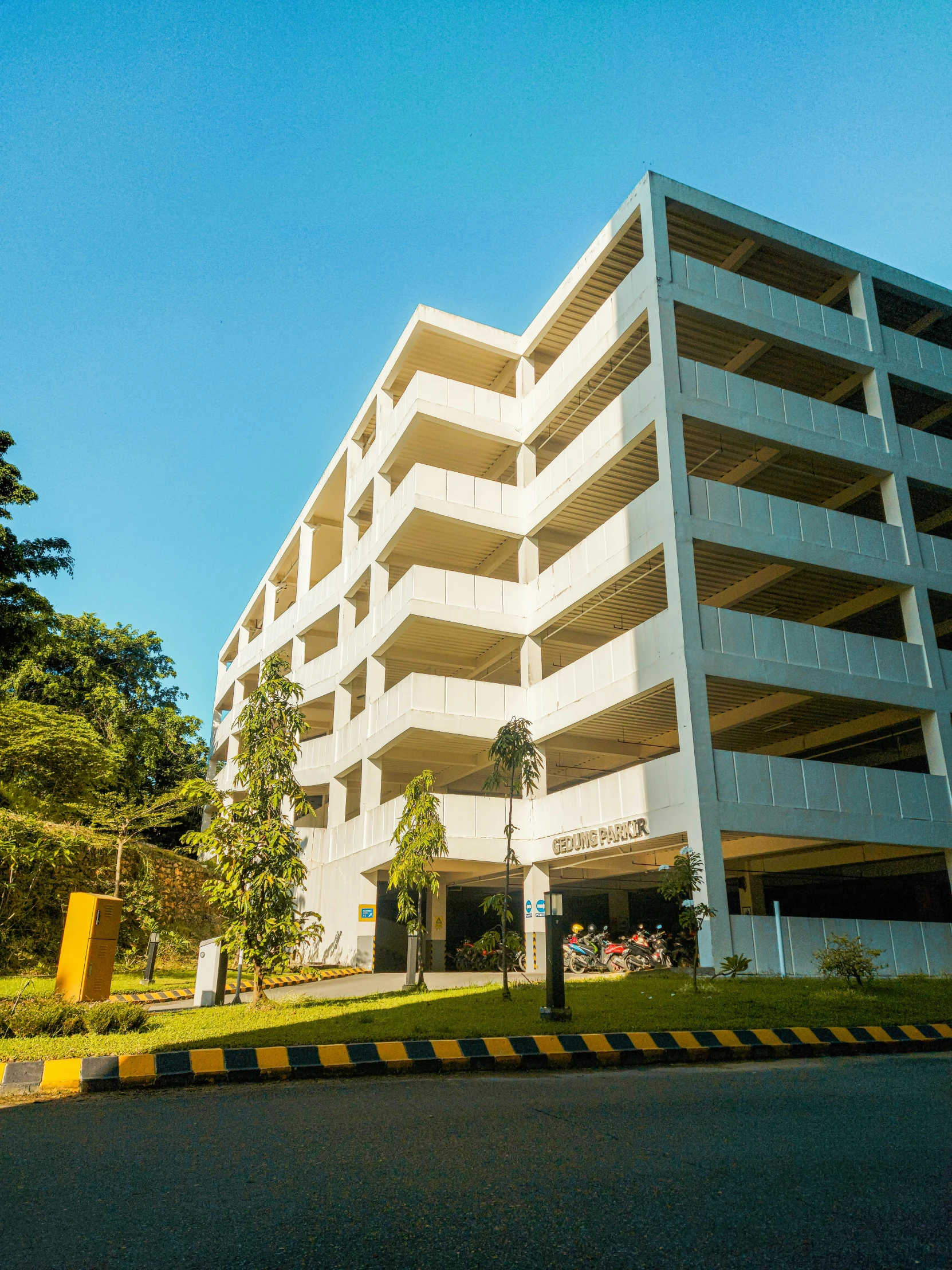 an apartment building in a park with trees around