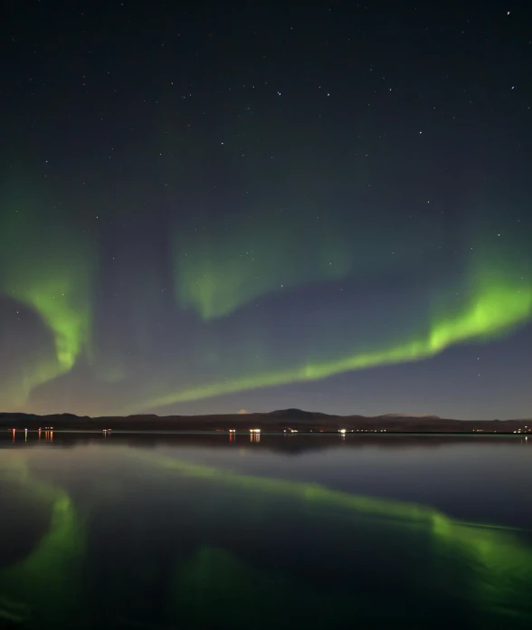 the sky is full of green and purple lights