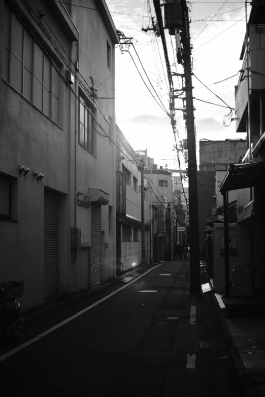 a long empty alley lined with tall buildings