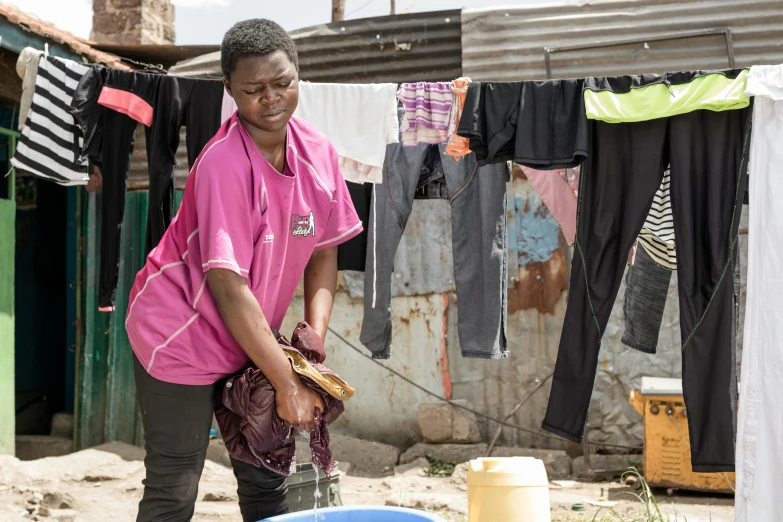 a woman in pink shirt by clothes line