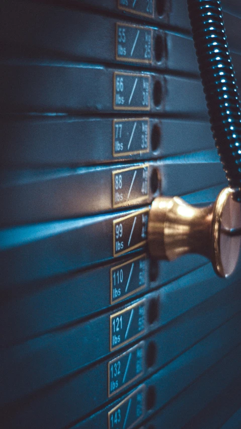 a metal wall clock mounted to the side of a blue wall