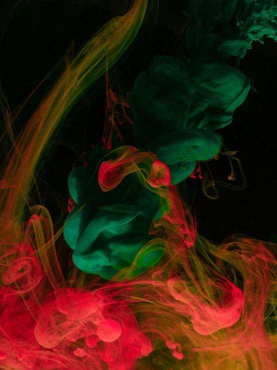 multicolored smoke moving across a black background