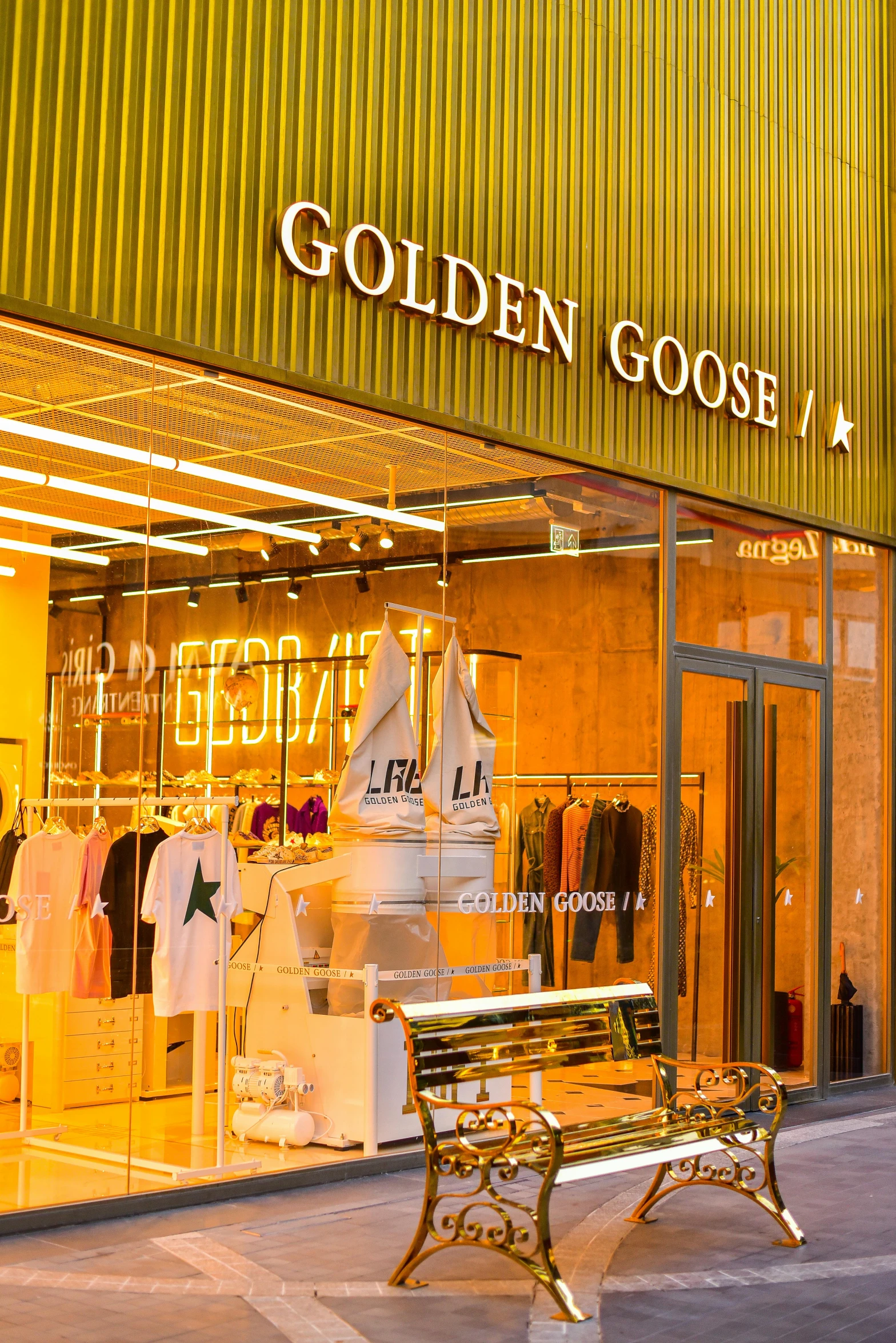a window display of gold goose at night