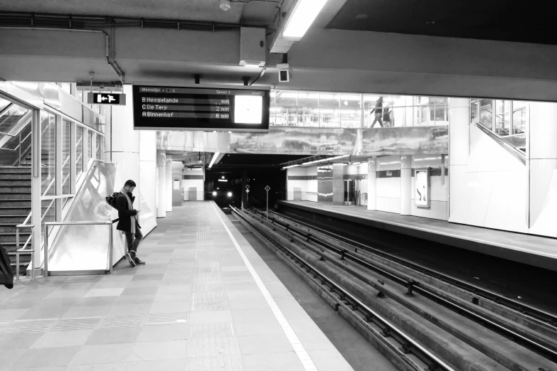 a person sitting in front of a subway platform