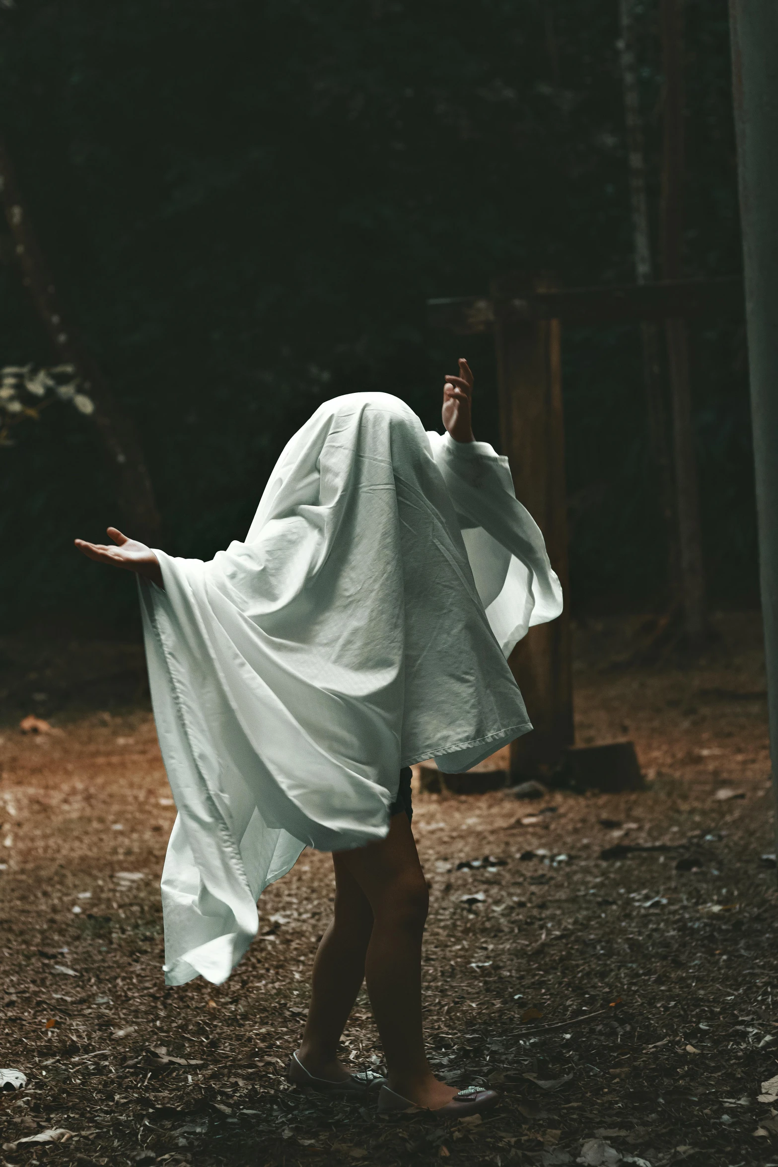 a woman in white walking on ground with her arms spread