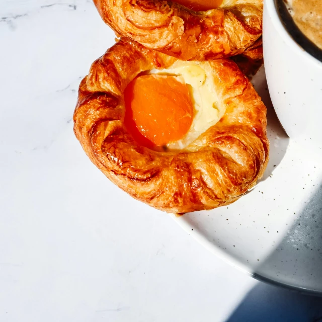 a plate topped with pastry and an egg