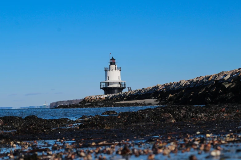 a light house sitting at the edge of the ocean