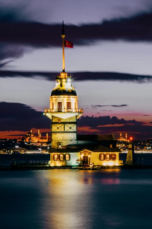 clock tower lit up in a city at night