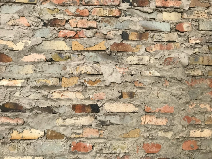 a very tall brick wall with a clock on top of it