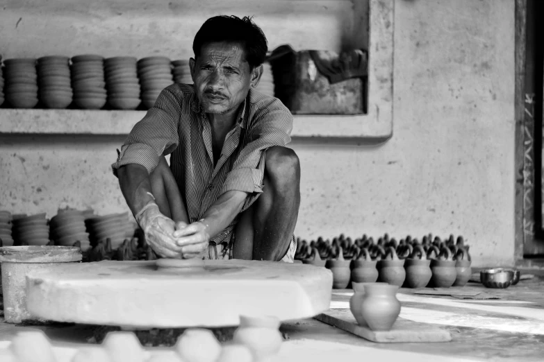 a man kneeling down next to some kind of thing