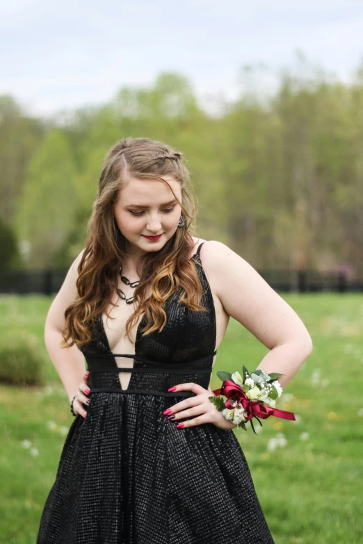 a woman in black dress with red accents