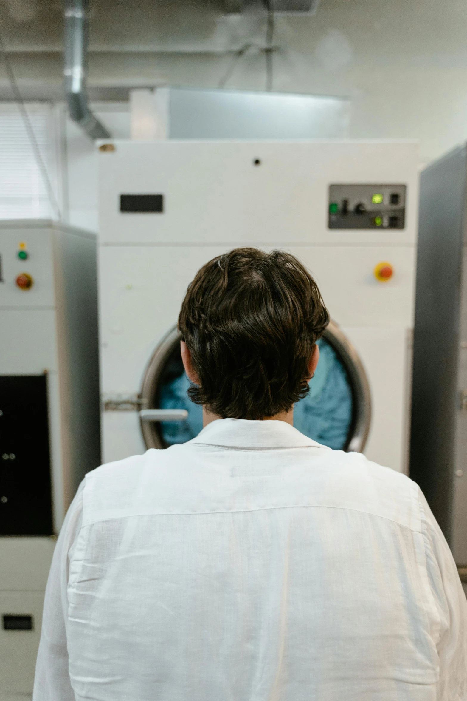 a man stands in front of a white machine