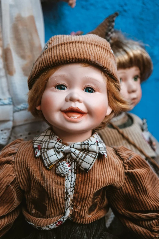 an old fashioned doll with a tie and a knit hat