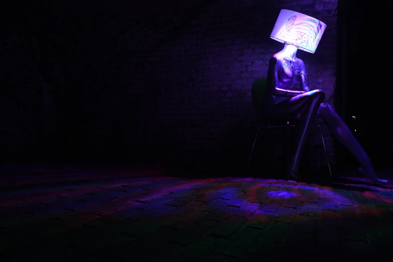 neon light illuminating a person's head and neck on a chair