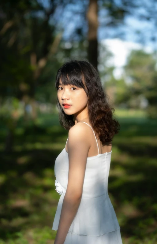 a woman in a white dress posing for a picture