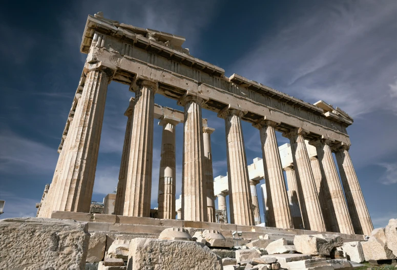 an old greek temple is shown against the sky