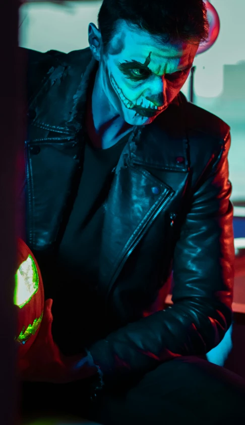 a man in black leather with halloween makeup on