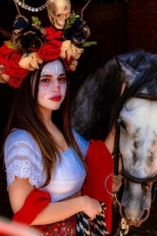 a woman is wearing a white top and holding onto a horse