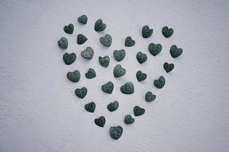 a heart made out of rocks sitting on the beach