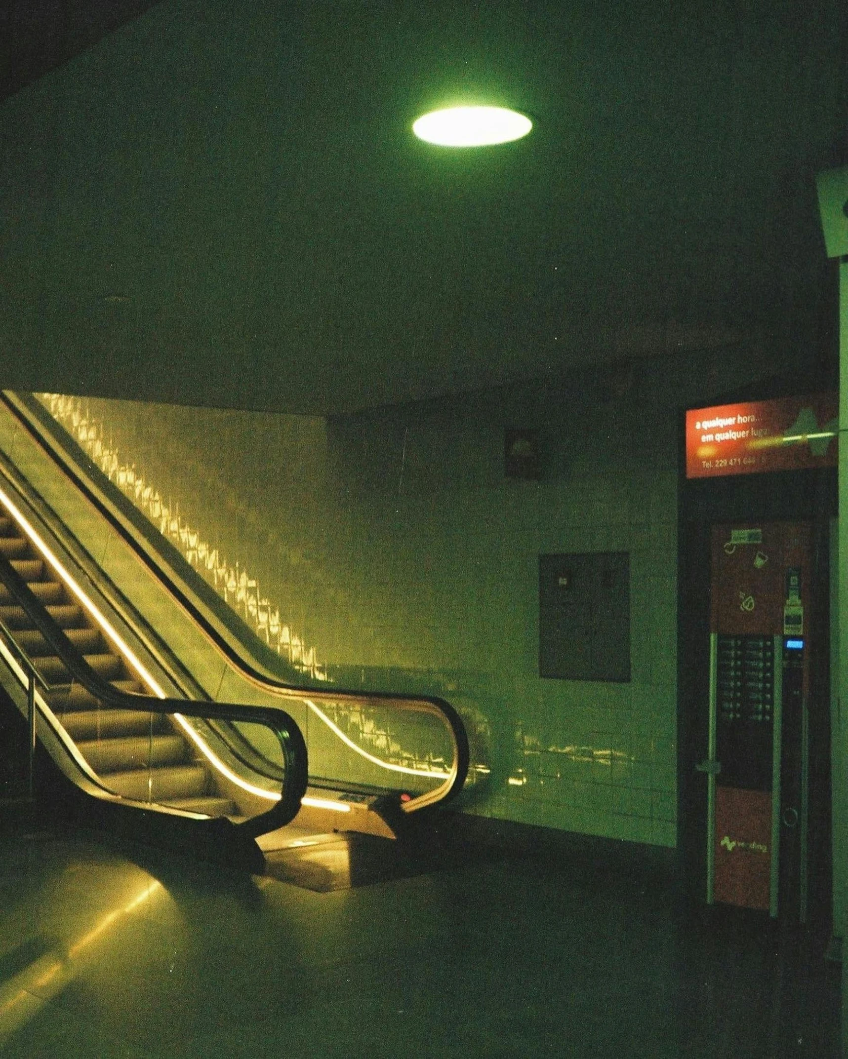 there is a long escalator in a subway station