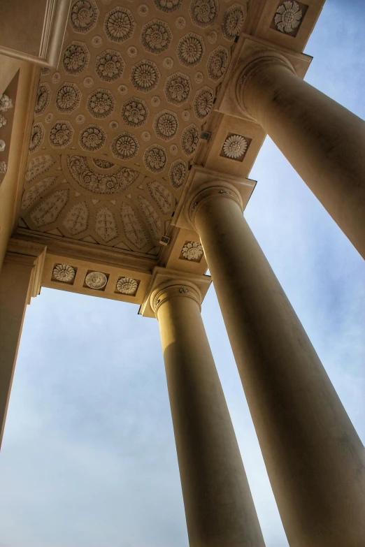 a group of pillars under a blue sky